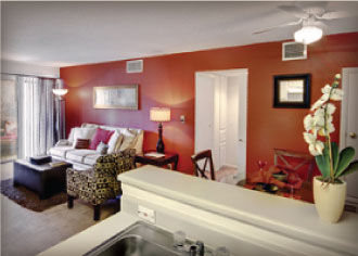 Living room with ceiling fan and light, carpet flooring, couch seating, accent wall, and window
