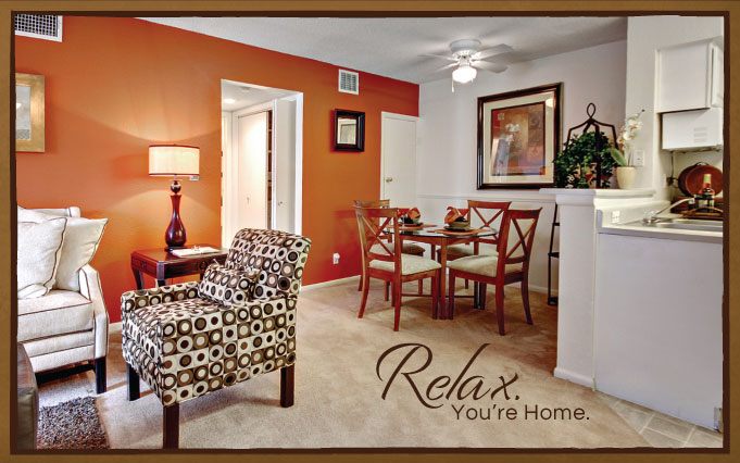 Dining room with table seating, carpet flooring, access to couch, ceiling fan and light