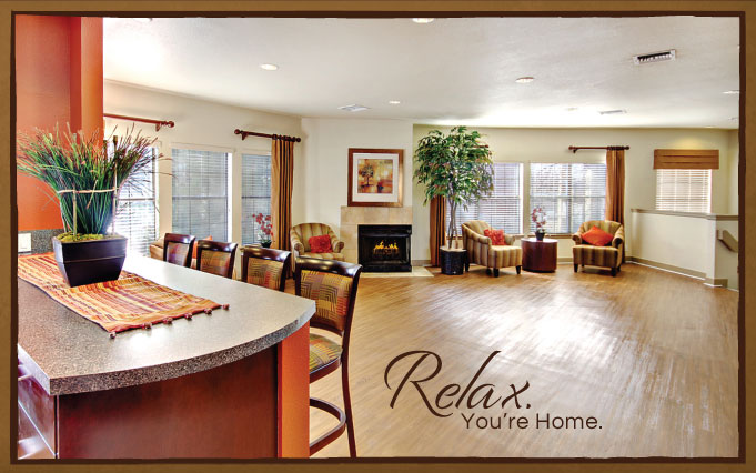 Living room with wood-style flooring, designer lighting, fireplace, lounge seating and bar area
