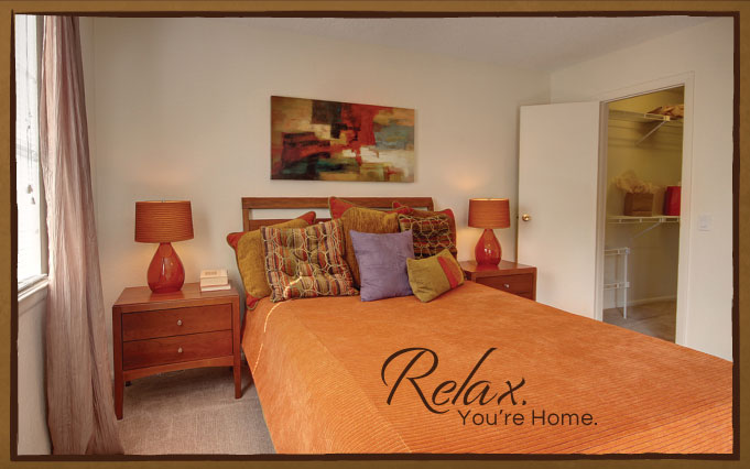 Bedroom with night stands and lamps, carpet flooring, access to closet, and window